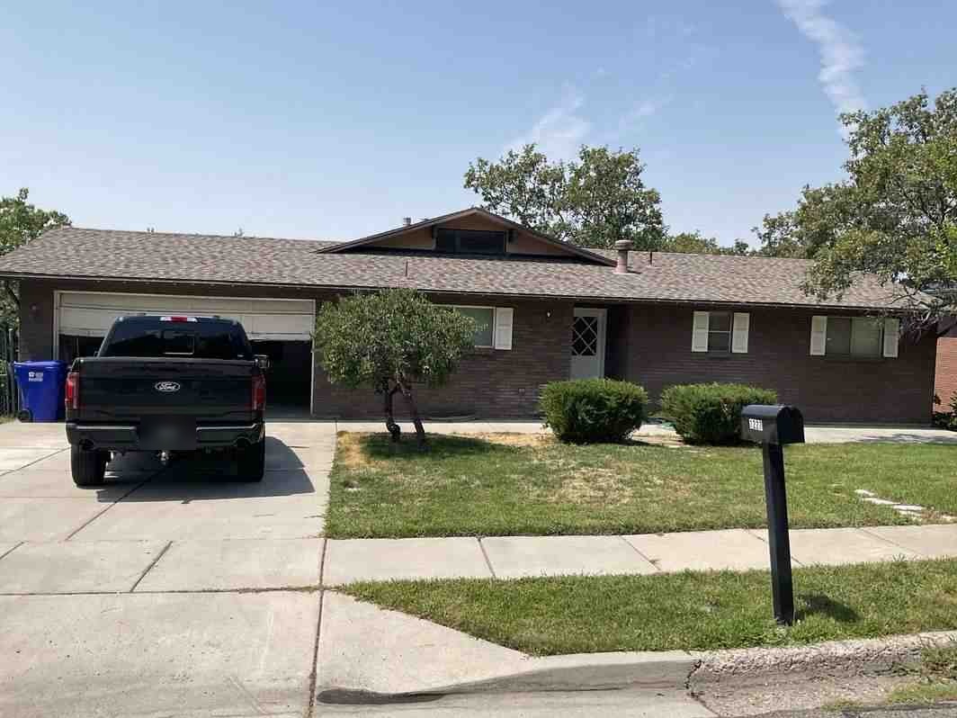Front of the one-story brick home at 1227 North 400 East, with its attached two-car garage and front lawn